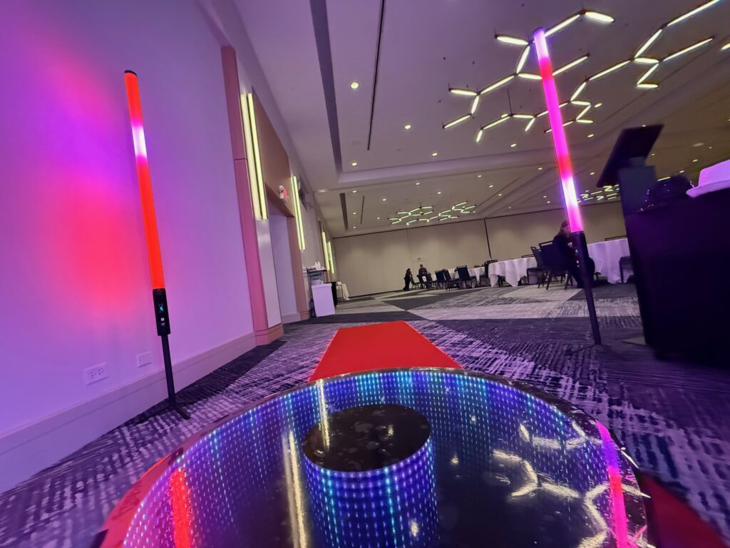 360 photo booth setup with led lighting walkway and red carpet entrance for wedding or event experience